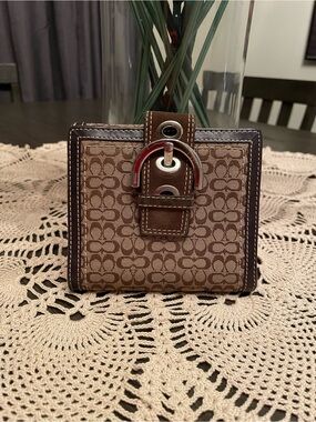 Coach Signature Soho Buckle bifold wallet in brown and tan monogram canvas